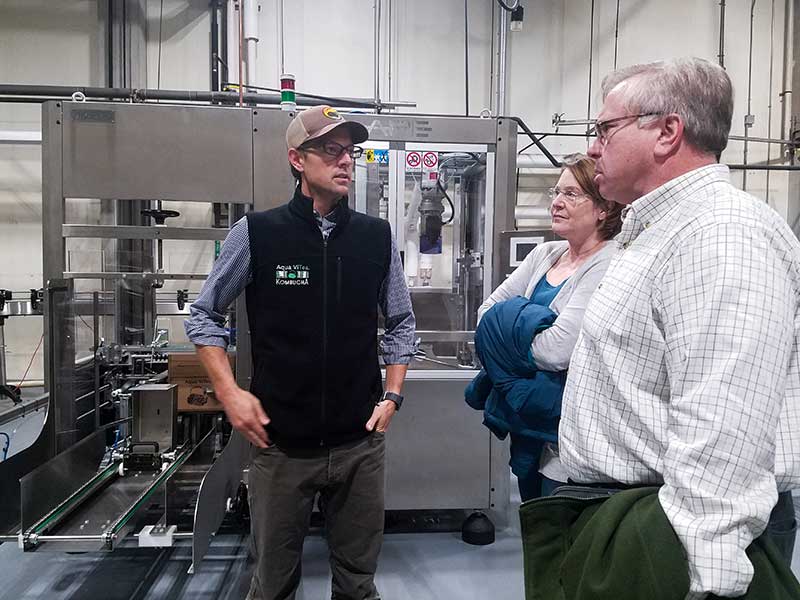 Fred Kenney, ACEDC Executive Director & Elizabeth Burdine, ACEDC Finance Director tour Aqua Vitea's new bottling line with Jordan Benjamin, AquaVitea CFO