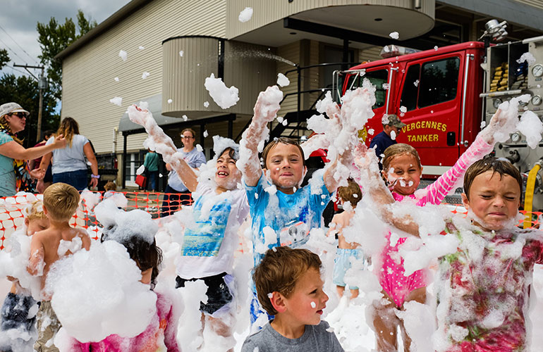 Kids playing with bubbles at a Vergennes Day event