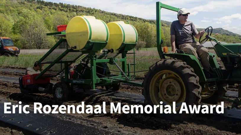 Farmer Eric Rozendaal riding a tractor in a field in the spring