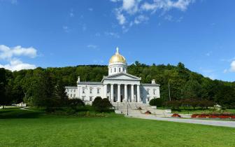 A photo of the Vermont State House in summer